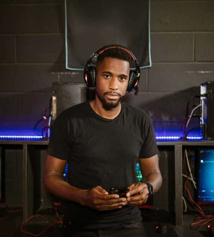 A focused gamer in a modern setup, wearing headphones, immersed in esports.